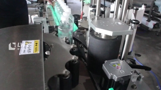 Machine d'étiquetage de bouteilles rondes à positionnement de roue en étoile